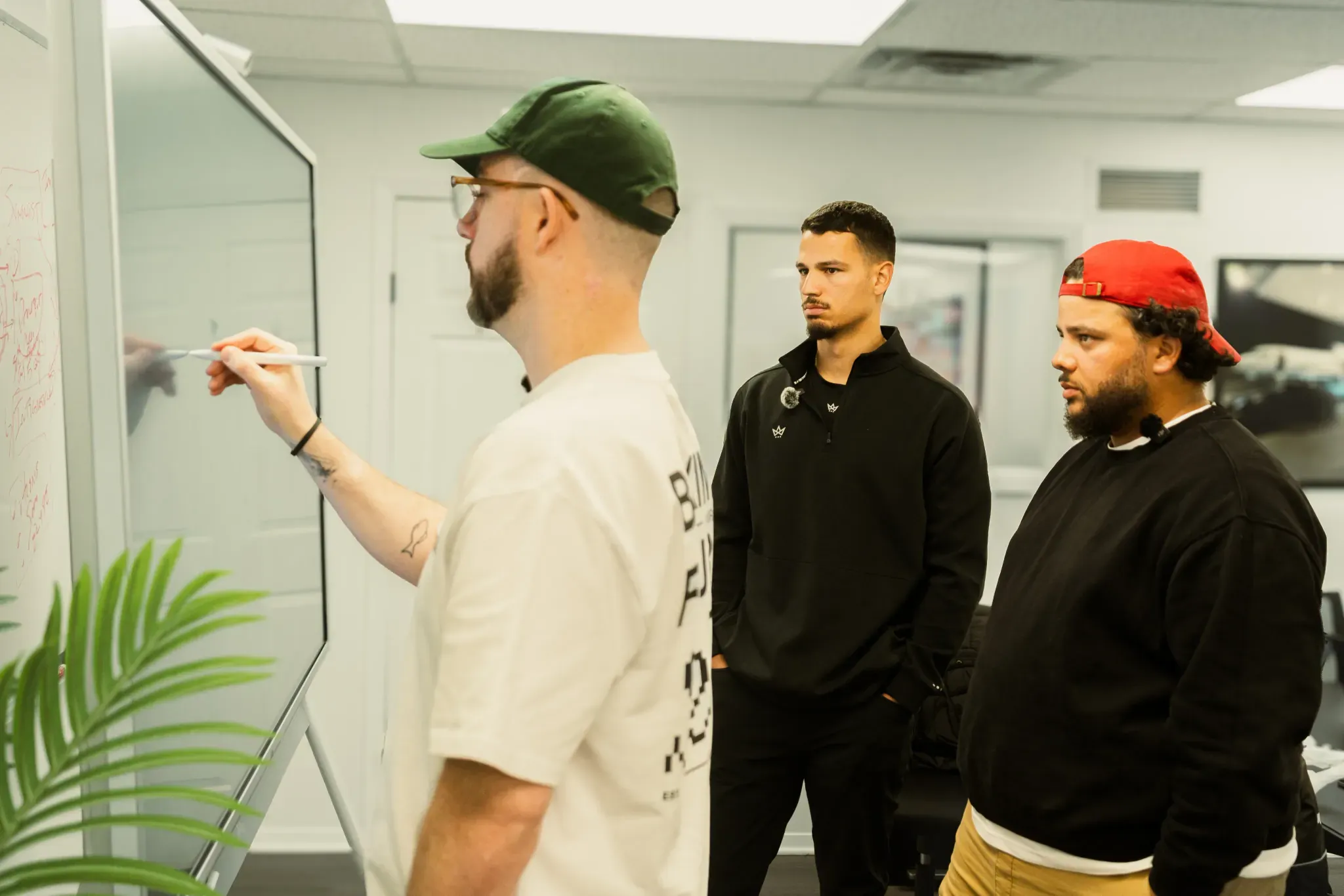 Drew and the team at a whiteboard in the studio